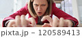 Aggressive worker stretches out hands typing on keyboard 120589413