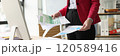 Female accountant in pink jacket does paperwork in premise 120589416