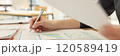 Secretary examines reports with diagrams and statistics 120589419