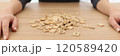 Woman puts hands on sides of wooden cubes pile lying on table 120589420