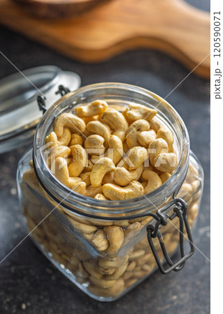 Roasted cashew nuts in jar on black table. Roasted cashew nuts in jar on black table. 120590071