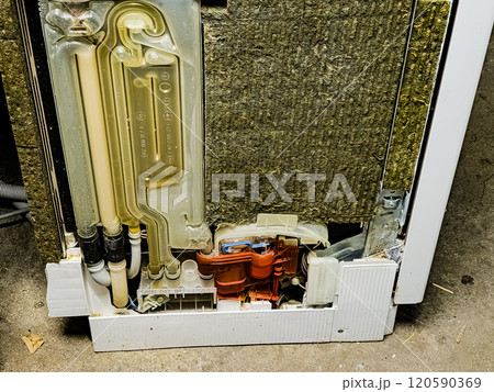 Side view of the dishwasher without the top panel. Working system for pumping and draining water into the device. After renovation. Side view of the dishwasher without the top panel. Working system for pumping and draining water into the device. After renovation. 120590369