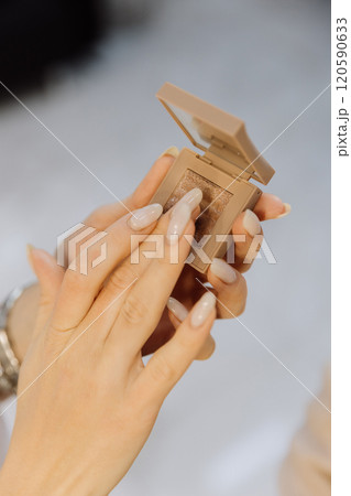 Applying glittery eyeshadow with precision for a flawless makeup finish 120590633