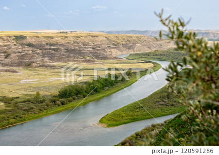 View to the river in the valley among badlands from the top of the hill. 120591286