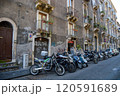 Motorcycles are parked in front of a building with falda sign 120591689