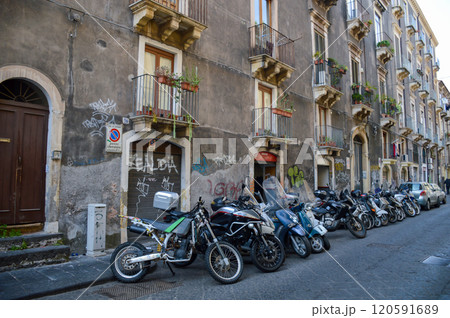 Motorcycles are parked in front of a building with falda sign 120591689