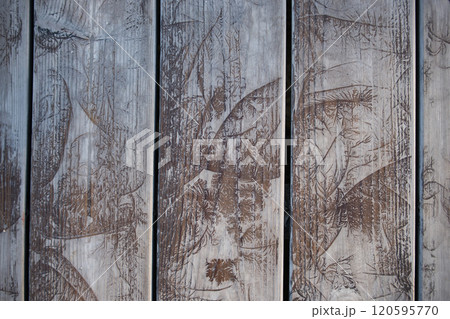 Close-Up of Weathered Wooden Planks With Leaf Patterns Close-Up of Weathered Wooden Planks With Leaf Patterns 120595770