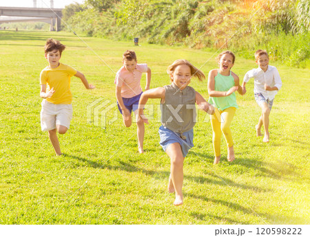 Barefoot kids running on green grass Barefoot kids running on green grass 120598222