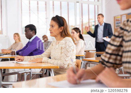 Young woman working during group business training 120598276