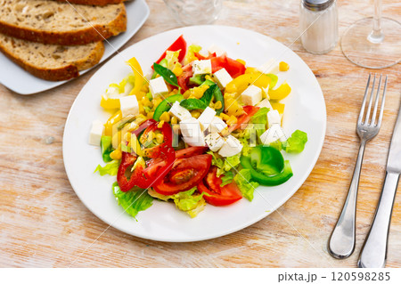 Salad with cheese, tomato, peppers, and corn 120598285