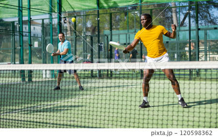 African american man padel tennis player trains on the court African american man padel tennis player trains on the court 120598362