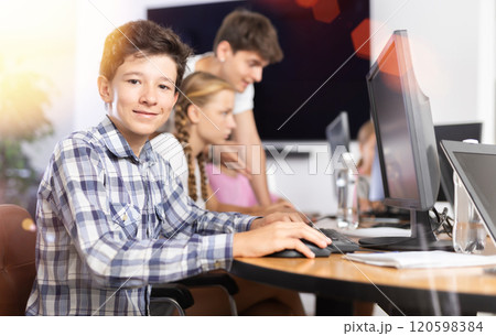 Boy student learning to work on computer in classroom 120598384