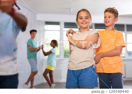 Active preteen children practicing Ballroom dances in pairs in training hall Active preteen children practicing Ballroom dances in pairs in training hall 120598440