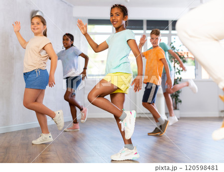 Smiling african american tween girl learning dynamic dances in choreography class Smiling african american tween girl learning dynamic dances in choreography class 120598481