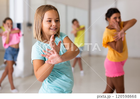 Young girls and boys performing modern dance in studio Young girls and boys performing modern dance in studio 120598668