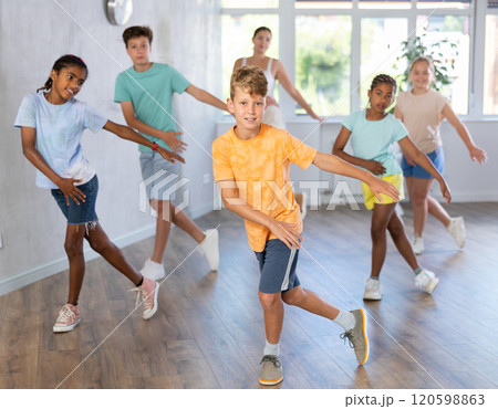 Active preteen children practicing Hip-hop dance with young trainer 120598863