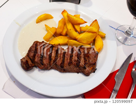 Tasty beef steak with baked potatoes and roquefort 120599097
