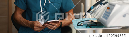 Holding Smartphone in Hospital Room Near Medical Equipment 120599225