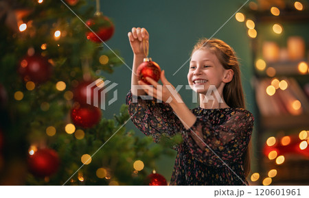 Child near Christmas tree indoors Child near Christmas tree indoors 120601961