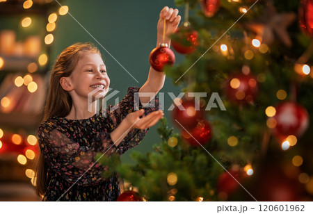 Child near Christmas tree indoors 120601962