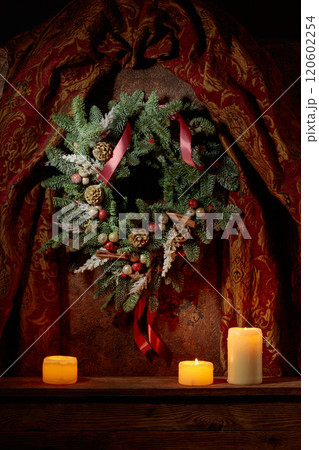 Christmas wreath and burning candles on a vintage background. 120602254