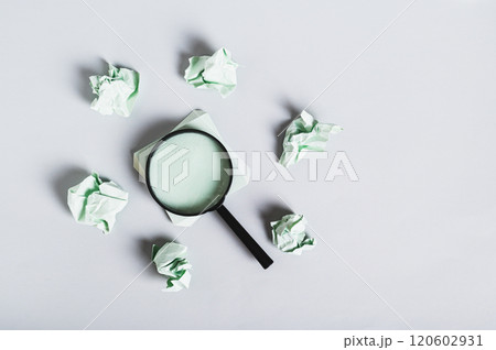 Burnout breaks concept. Magnifier among the papers for writing on the desk top view 120602931