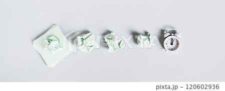 Burnout breaks concept. Crumpled note papers and alarm clock top view web banner 120602936