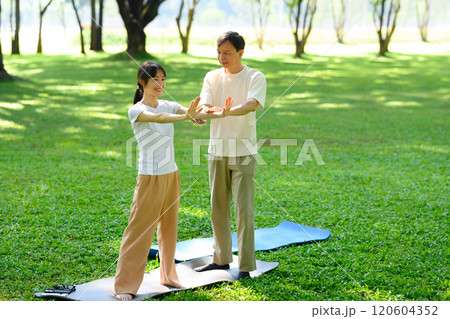 Father and daughter practicing Tai Chi in serene park. Mindfulness and health concept Father and daughter practicing Tai Chi in serene park. Mindfulness and health concept 120604352