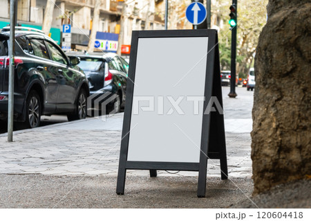 Blank white sandwich board on a street 120604418