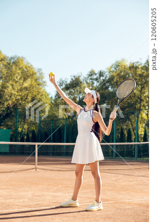Beautiful female tennis player having a workout on the tennis court Beautiful female tennis player having a workout on the tennis court 120605205