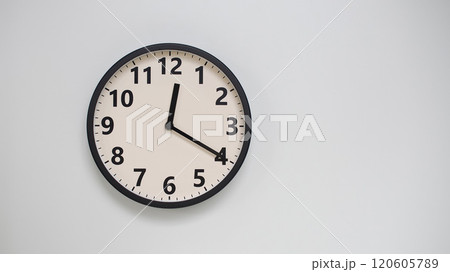 Classic Black-Edged Clock on White Background at 12.20/00.20 - Perfect for Time Management and Text Space 120605789