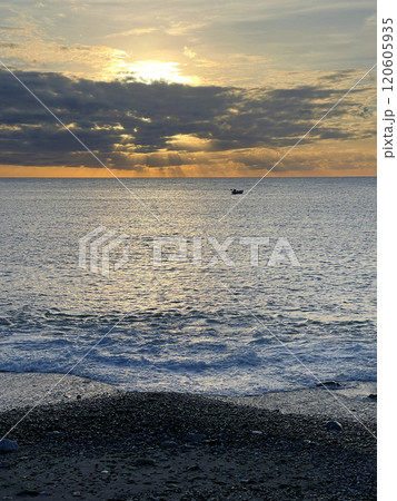 Boat with fishermen on sea. Nature and sunset. Seascape and horizon line. Dramatic scene. Boat with fishermen on sea. Nature and sunset. Seascape and horizon line. Dramatic scene. 120605935