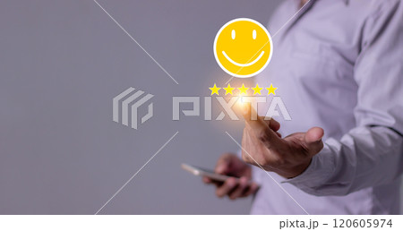 Consumer Satisfaction, Young Man with smartphone hand holding emoji five star to review Consumer Satisfaction, Young Man with smartphone hand holding emoji five star to review 120605974
