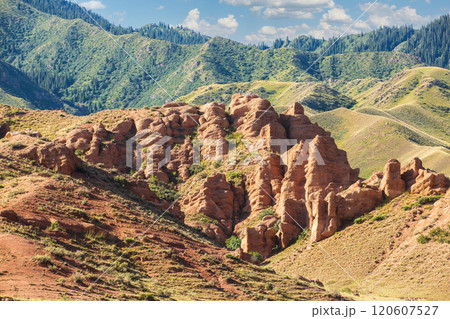 Experience the breathtaking landscape featuring stunning red rock formations amidst a captivating mountainous terrain of Tian Shan. Experience the breathtaking landscape featuring stunning red rock formations amidst a captivating mountainous terrain of Tian Shan. 120607527
