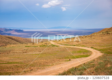 Road through the mountainous terrain to Lake Bartogayi in Almaty region, Kazakhstan. Amazing nature of Central Asia. Road through the mountainous terrain to Lake Bartogayi in Almaty region, Kazakhstan. Amazing nature of Central Asia. 120607528