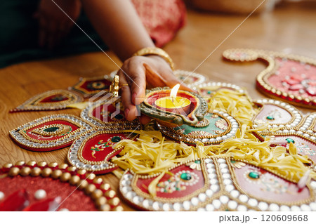 Celebrating Diwali with Traditional Oil Lamps and Rangoli 120609668