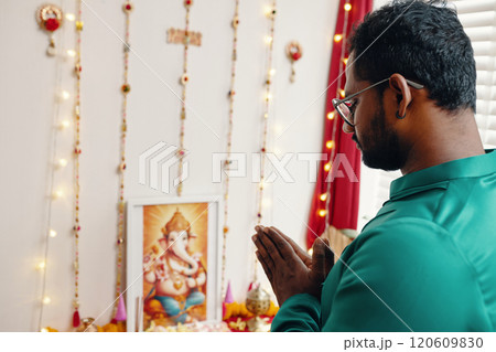 Praying to Ganesha at Home with Decorated Altar Praying to Ganesha at Home with Decorated Altar 120609830
