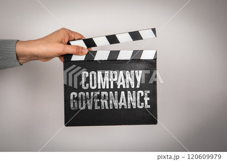 Company governance. Hand holding movie clapper Company governance. Hand holding movie clapper 120609979