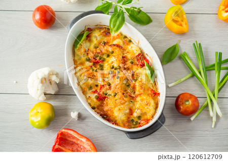 cauliflower baked with sweet pepper and vegetables under cheese 120612709