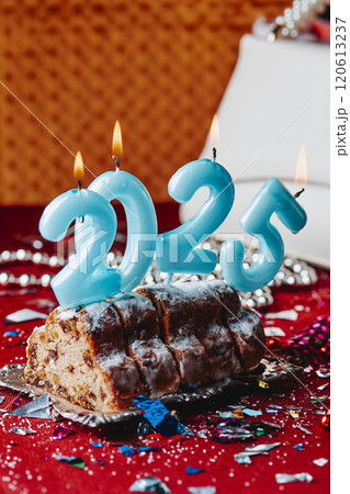 candles forming number 2025 on a cake 120613237