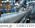 Selective focus of A robot arm in a dairy factory is picking up a stack of white glass bottles filled with fresh pasteurized milk. 120613350