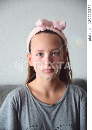 girl with a cosmetic mask on her face 120613379