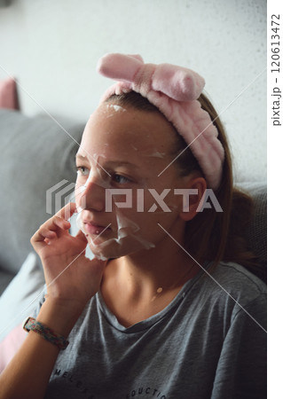 girl with a cosmetic mask on her face girl with a cosmetic mask on her face 120613472