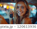 Caucasian woman showing car keys in hand sitting inside car in showroom. 120613936