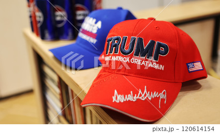 Kyiv, Ukraine - November 5, 2024: hats featuring "Kamala Harris 2024 For President" in blue and "Trump Make America Great Again" in red 120614154