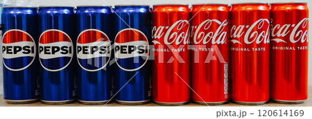 Kyiv, Ukraine - November 5, 2024: Close-up of neatly arranged Pepsi and Coca-Cola cans, showcasing a vibrant contrast of their iconic blue and red branding 120614169