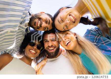 Group of young diverse friends smiling and looking down at camera, enjoying time together 120614733