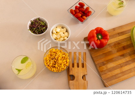 Preparing fresh salad with vegetables and tofu, ingredients on kitchen counter 120614735