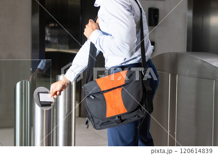 Scanning ID card, business professional entering office building with shoulder bag Scanning ID card, business professional entering office building with shoulder bag 120614839