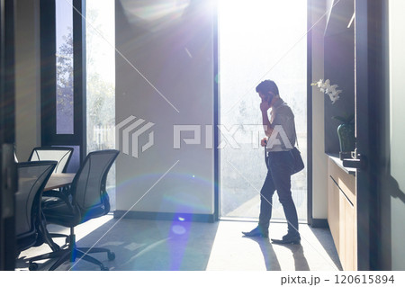 Walking in office, asian man talking on smartphone 120615894